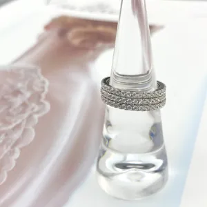 Close-up of three stackable 925 sterling silver eternity bands with pavé zircon stones