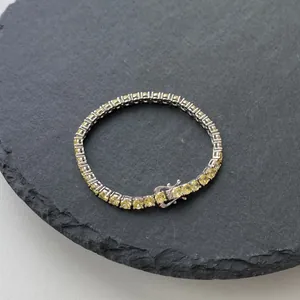 Macro shot of 4mm S925 silver tennis bracelet with yellow zircon stones and secure clasp