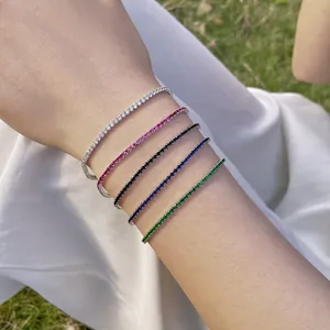 Close-up of five colorful S925 sterling silver tennis bracelets worn on a wrist