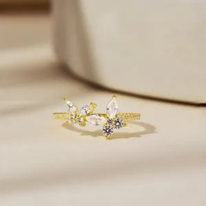 Detailed close-up of golden butterfly ring featuring sparkling zircon marquise stones