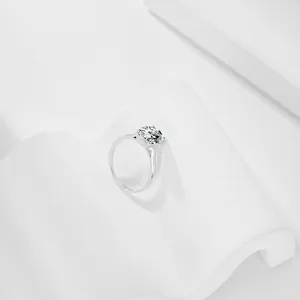 Close-up of a sparkling 5A zircon ring with an oval yellow stone on modern white pedestals