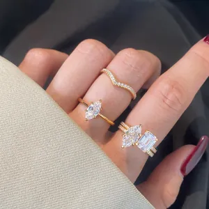 Detailed view of layered S925 sterling silver rings with marquise cut stones in champagne gold