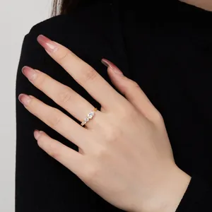 Close-up of golden S925 silver snake ring with pear-cut zircon on a model's hand