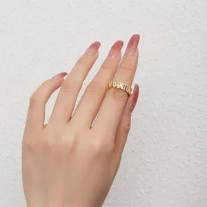 Close-up of gold S925 silver ring with oval and rectangular shimmering zircon stones