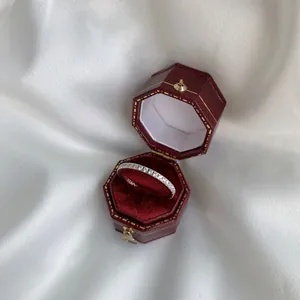 Macro shot of S925 sterling silver eternity ring with pavé zircons in a red velvet box