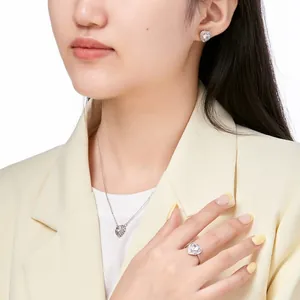 Close-up of S925 sterling silver heart necklace set with sparkling zircon on female model