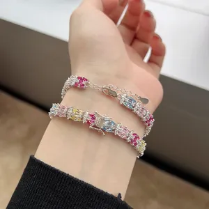 Bracciale in argento S925 con zirconi colorati e diamanti indossato su polso femminile