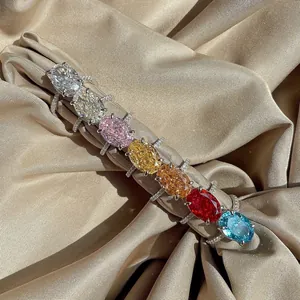 Detailed collection of colorful oval cut gemstone rings on elegant silk fabric