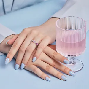 Detail of S925 silver ring with pink rectangular gems and white zircon on a model hand