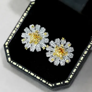 Detailed macro view of S925 silver daisy earrings with yellow gemstone and white diamonds