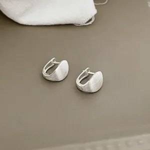 Detail showing the brushed matte texture and semi-arch U-shape of S925 silver earrings