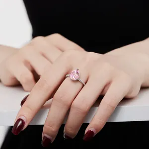 Elegant S925 silver ring with a pear-cut pink carbon diamond and pavé side stones