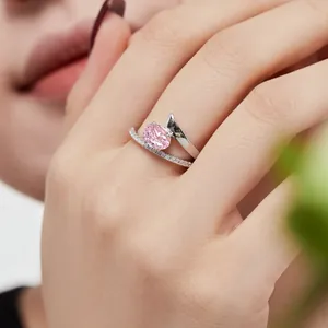 Macro shot of S925 sterling silver ring with pink oval zircon and crisscross pavé band