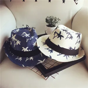 Detailed texture of kids' straw fedora hats featuring tropical coconut tree patterns