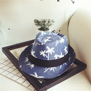 Detailed texture of blue straw Panama hat featuring white coconut palm tree prints