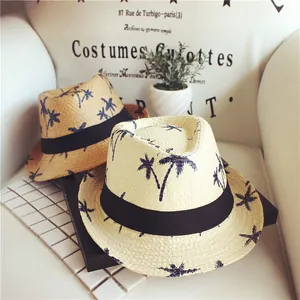 Straw beach hats with coconut tree prints and black ribbons for sun protection