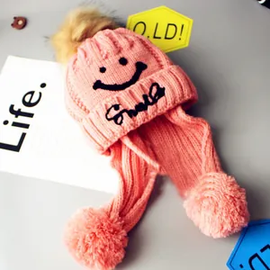 Pink knit winter hat with furry pom-poms and smile embroidery for boys and girls