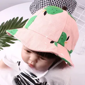 Pink cotton baby sun hat with green cartoon dinosaur pattern and white chin strap