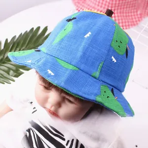 Close-up of baby sun hat with green pear pattern and decorative brown stem detail