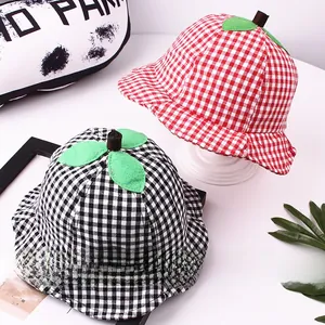 Detail of plaid cotton baby sun hats featuring a 3D leaf and stem design in red and black