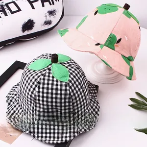 Detail of children's cotton sun hats with 3D leaf tops in pink fruit and plaid patterns
