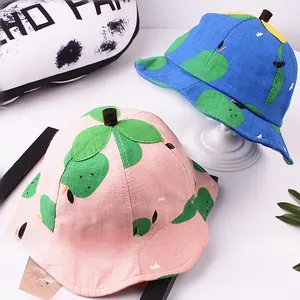 Detail of pink and blue baby sun hats featuring 3D stem and green leaf accents