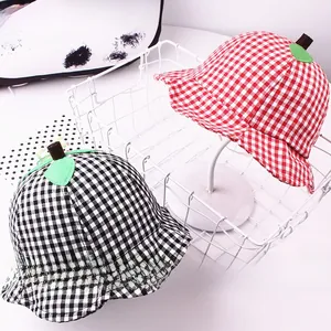 Detail of plaid cotton bucket hats with 3D green leaf design for kids sun protection