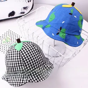 Detail of kids bucket hats featuring blue floral prints and classic black and white plaid