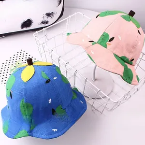 Detail of pink and blue kids bucket hats with cartoon leaves and cute stem top