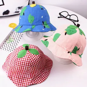 Detailed view of kids bucket hats in plaid and tropical prints with 3D leaf tops