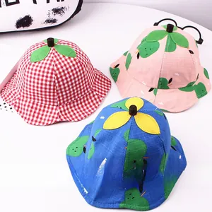 Detailed top view of plaid and fruit print cotton sun hats for toddlers with 3D leaf decor