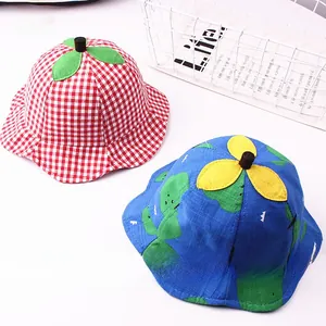 Detail of checkered kids sun hats with cute leaf and petal decorations on top