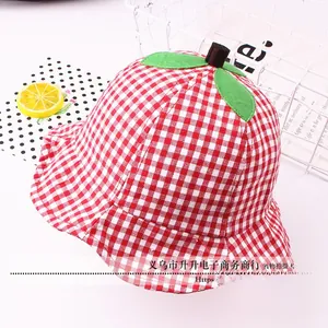 Detail of red checkered kids bucket hat with decorative green felt leaves on top