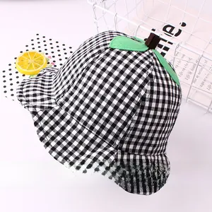 Detail of kids plaid bucket hat with green leaf and brown handle apple stem design