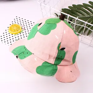 Pink bucket hat for kids with green fruit pattern and decorative stem on top detail