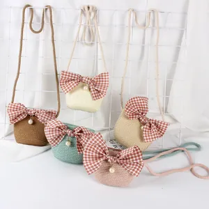 Detailed view of kids' mini straw crossbody bags in five colors with plaid bows and pearls