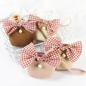 Handwoven straw crossbody bags for girls with bowknot and pearl pendant in four colors