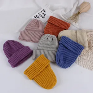 Multiple colorful ribbed knit beanies with wide folded cuffs for winter warmth