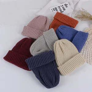 Detailed flat lay of ribbed knit baby beanies in seven various autumn winter colors