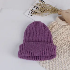 Detailed knit texture of a purple winter beanie with thick yarn and fold-over cuff