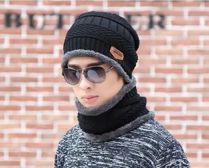 Detail of warm winter beanie and neck warmer set with thick fleece lining and knit pattern