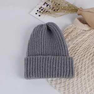 Close-up of grey ribbed knit beanie showing thick warm texture and premium wool blend fabric