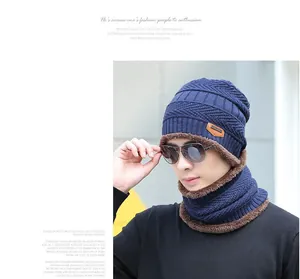 Close-up of navy knit hat and neck warmer with thick brown fleece lining for winter warmth