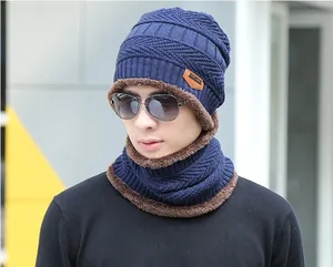 Close-up of navy blue winter knit beanie and neck warmer with soft brown faux fur lining