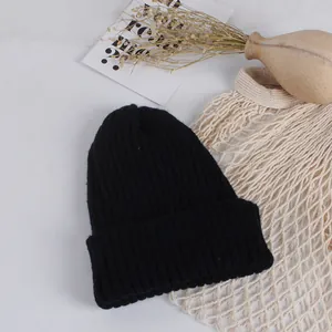 Close-up of black ribbed knit beanie featuring thick cuff and warm winter texture