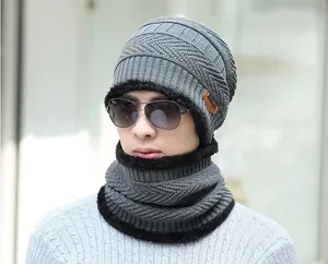 Detail of grey knitted winter hat and neck warmer set with thick fleece lining and leather patch