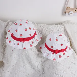 Sweet cotton sun hat for girls with strawberry print, wavy brim and red ribbon details