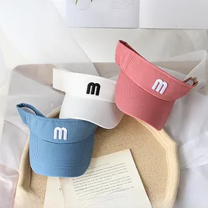 Detailed embroidery of letter m on kids breathable open top sun visors in various colors
