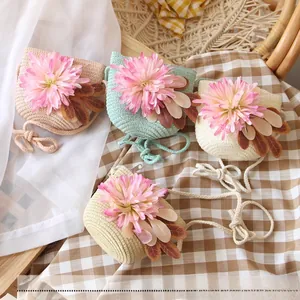Detailed close-up of four colorful woven straw crossbody bags for kids with flower decor