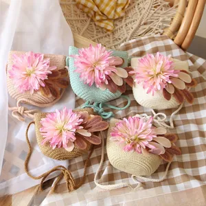 Detailed overhead view of handmade straw cross-body bags for girls in five assorted colors
